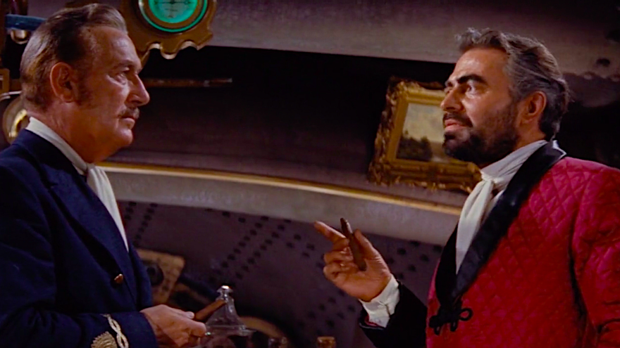 El profesor Aronnax (interpretado por Paul Lukas, a la izquierda) recibe el puro "de algas" que le ofrece el capitán Nemo (James Mason) en '20.000 leguas de viaje submarino', el filme de 1954. (Captura)