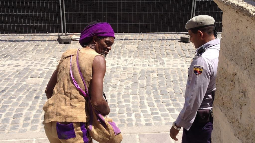 Un agente de policía echa a un mendigo de la Plaza de la Catedral. (La Habana)