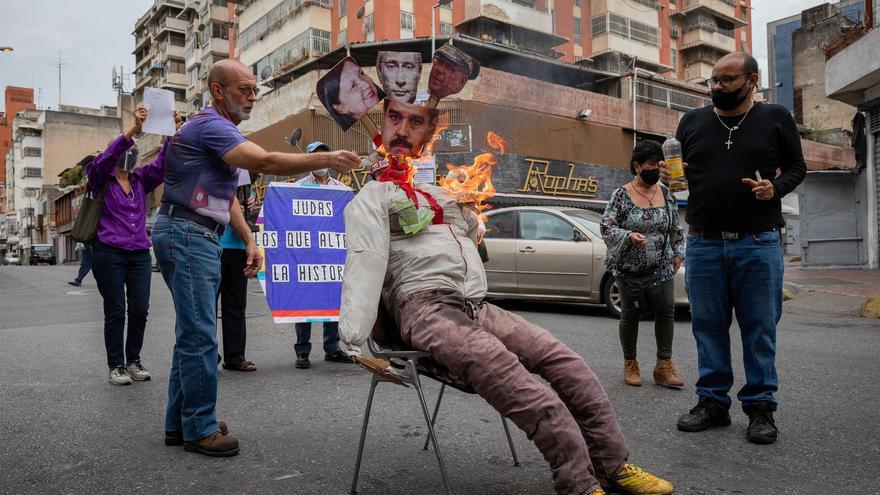 Monigote de cuatro cabezas recreando la muerte de Judas con los rostros de Vladímir Putin, Nicolás Maduro y otras figuras representativas de la política de Venezuela, este domingo en Caracas. (EFE/Rayner Peña R.)