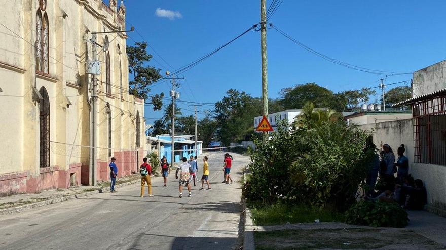 En la calle que está al costado de la iglesia que perdió el campanario los muchachos juegan voleibol y levantan mucho polvo. (14ymedio)